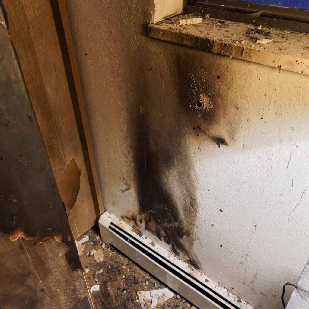 Scorched wall and skirting board after a fire