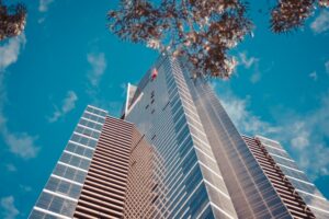 low angle shot tall business building with blue cloudy sky