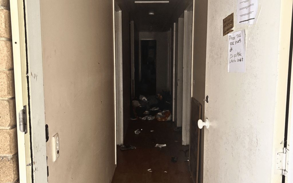 A dark, cluttered hallway in a property requiring professional meth decontamination services by AllAces.