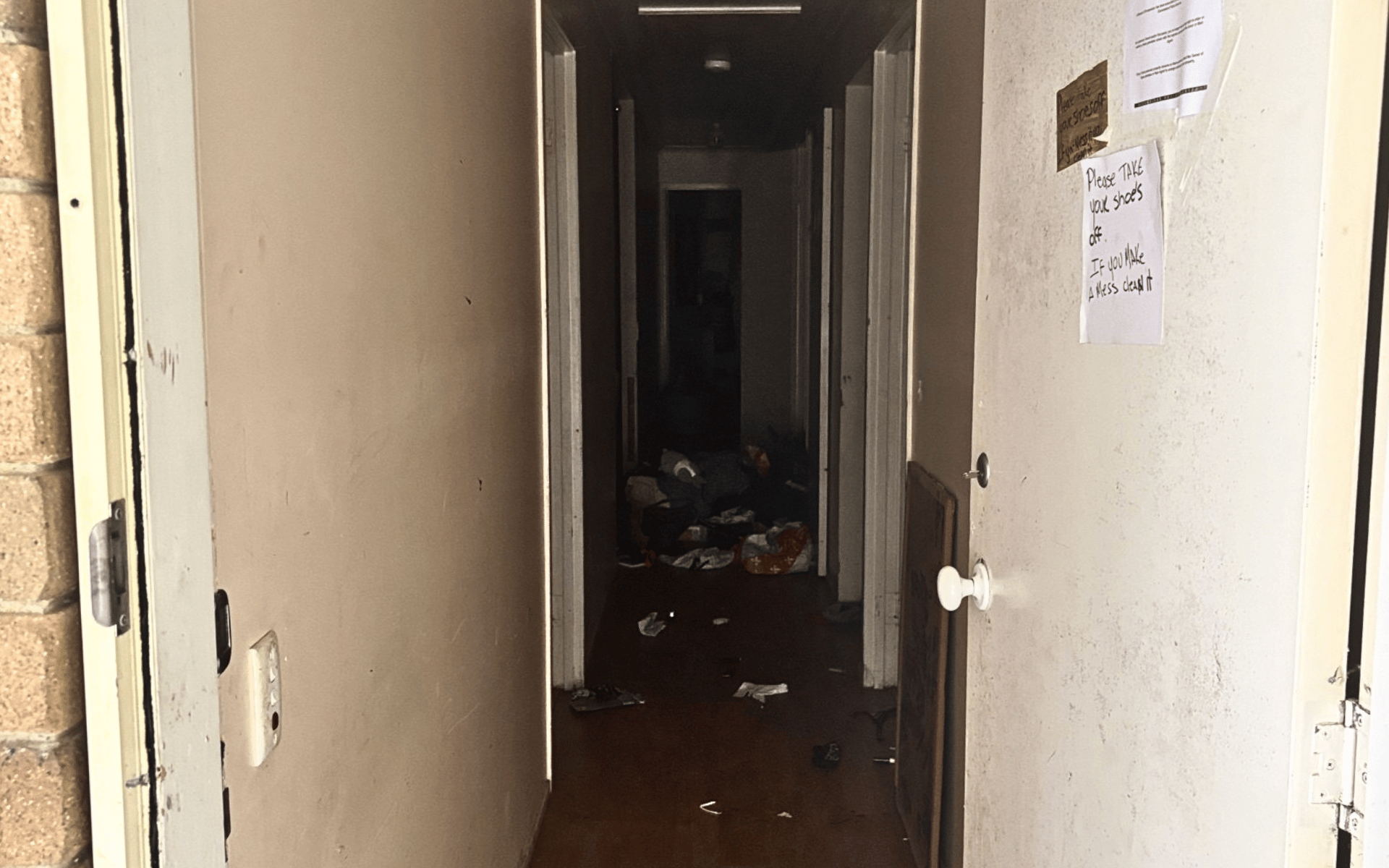 A dark, cluttered hallway in a property requiring professional meth decontamination services by All Aces.