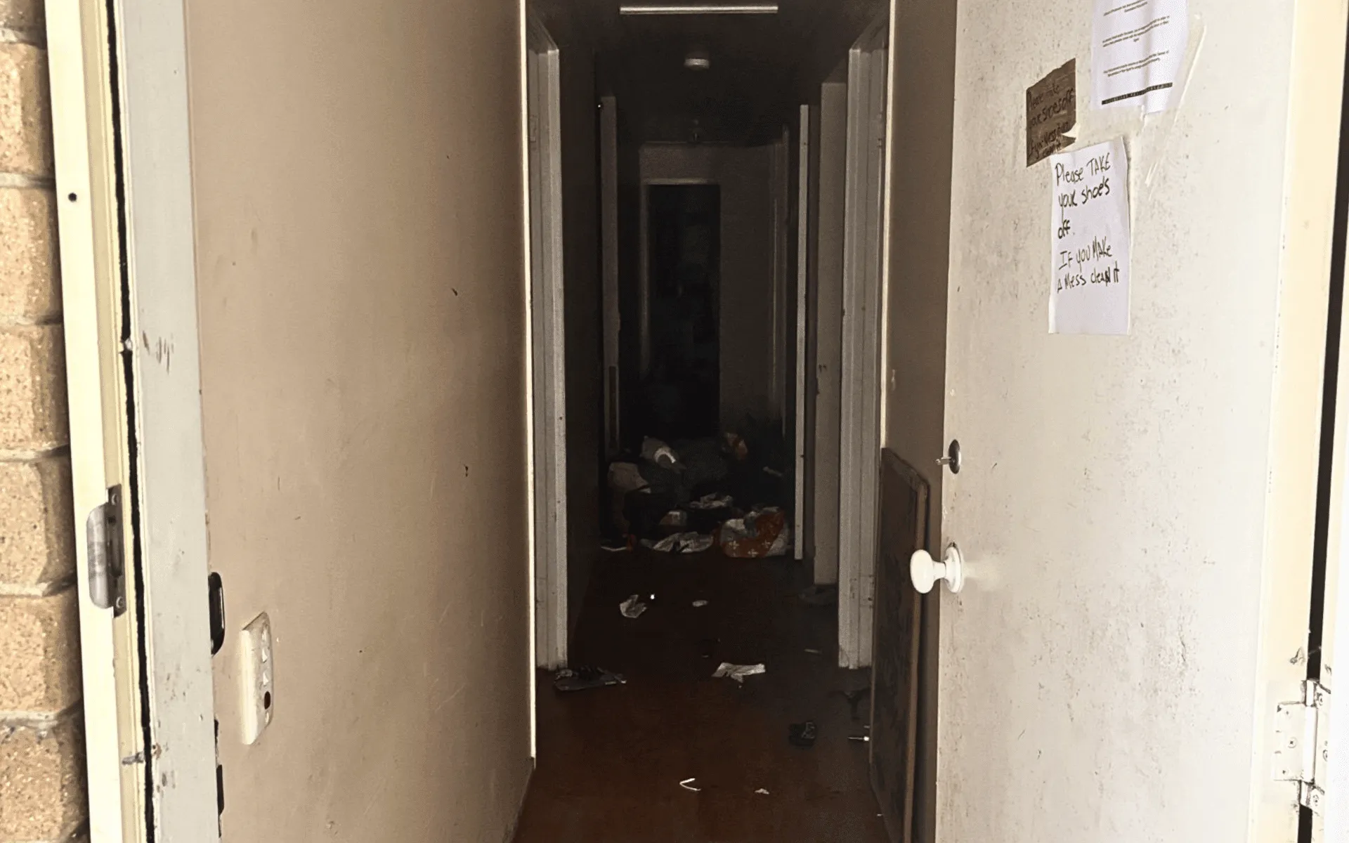 A dark, cluttered hallway in a property requiring professional meth decontamination services by All Aces.