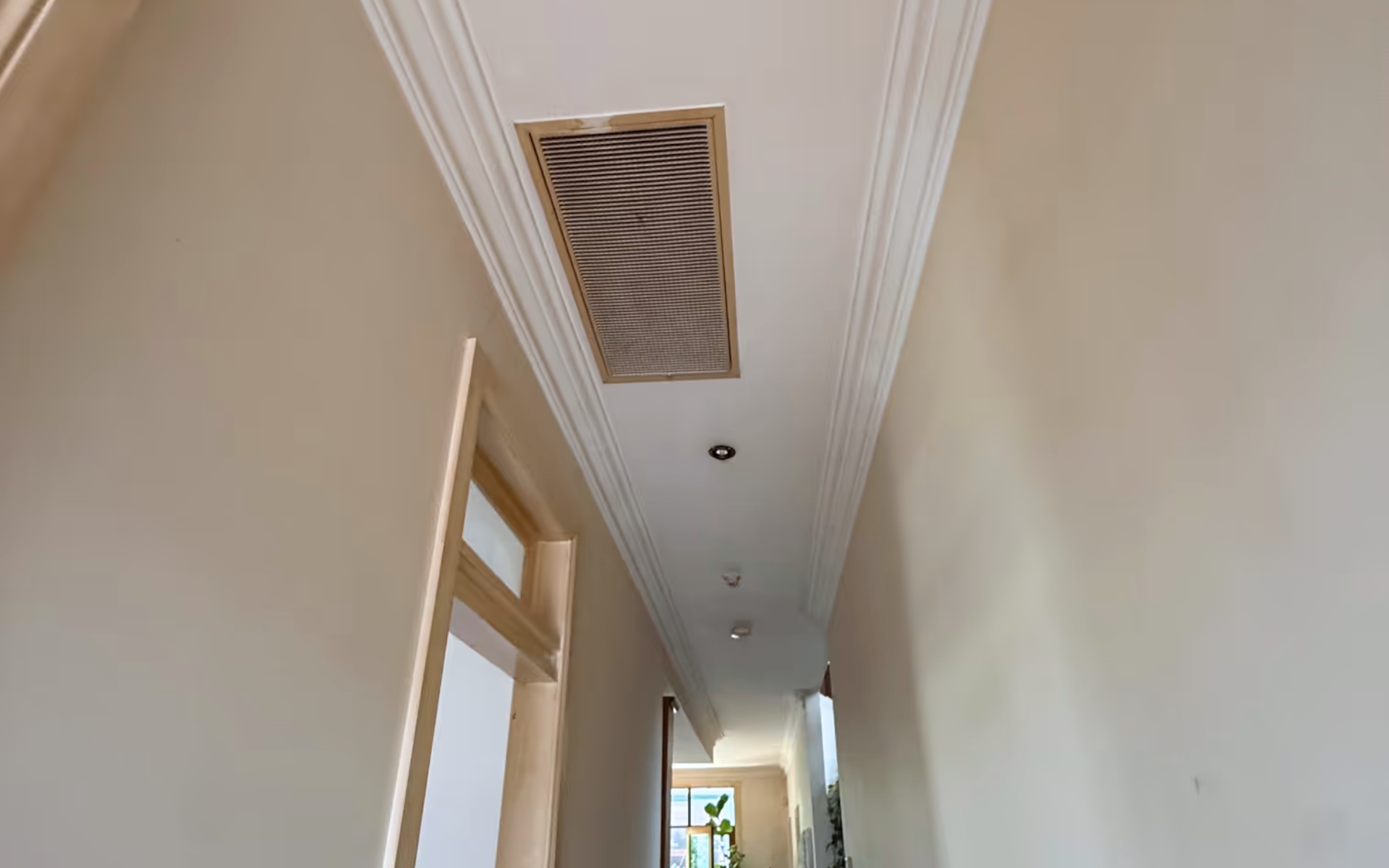 Hallway after nicotine clean-up showing removal of nicotine staining and smoke residue, restoring clean and bright walls, trims, and surfaces.
